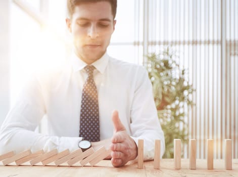 Businessman with dominoes in the office