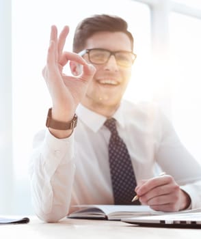business, startup, gesture and people concept - happy businessman or creative male office worker with computers showing ok hand sign