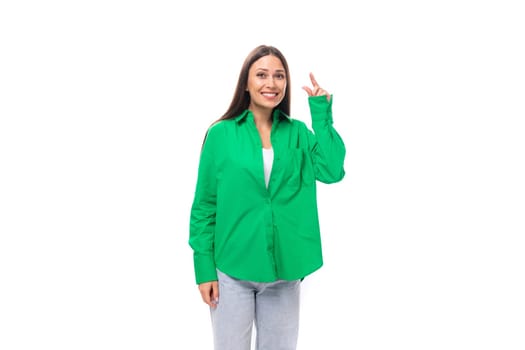 well-groomed attractive young brunette woman with makeup in a green shirt on a white background with copy space.