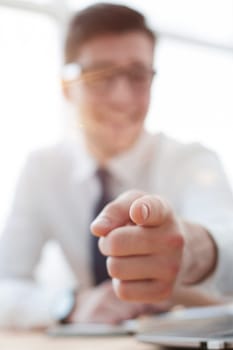 businessman pointing his finger to you at office