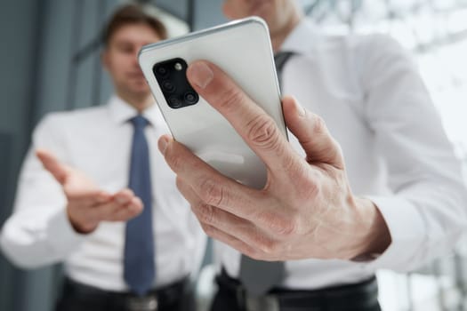 man using smartphone pressing finger, reading social media internet, typing text or shopping online. Mobile phone at home or work.