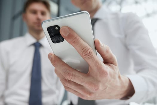 man using smartphone pressing finger, reading social media internet, typing text or shopping online. Mobile phone at home or work.