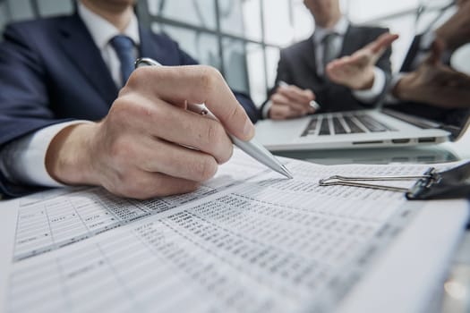 Close up businesspeople cooperate work together discussing company financial statistics