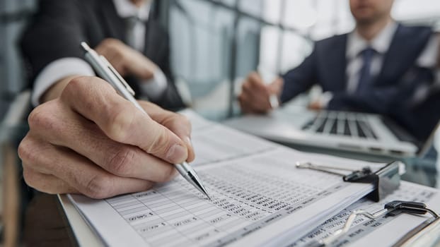 Close up businesspeople cooperate work together discussing company financial statistics
