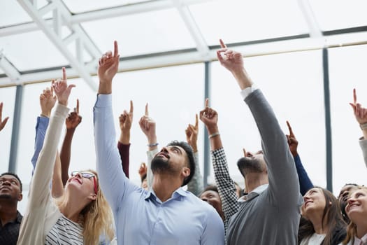 happy group of diverse young people holding their hands up