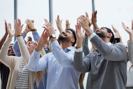 Group of young business people looking up