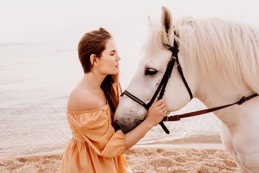 A white horse and a woman in a dress stand on a beach, with the sky and sea creating a picturesque backdrop for the scene