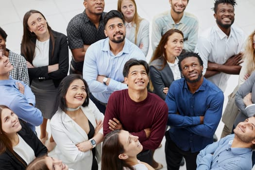 Group of successful business people looking up