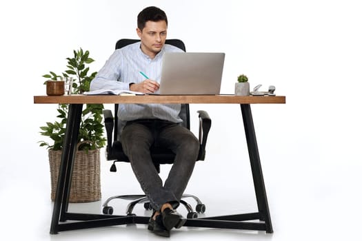 entrepreneur man using laptop computer for online work at table on white background