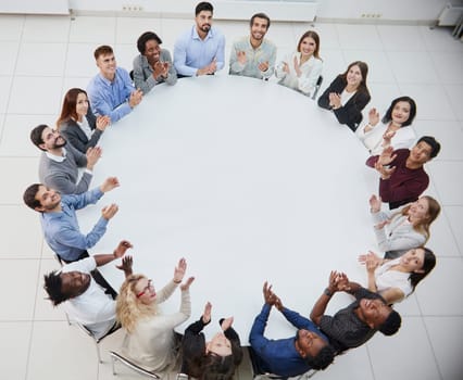 Clerks or colleagues sitting at round table and discussing ideas or brainstorming.