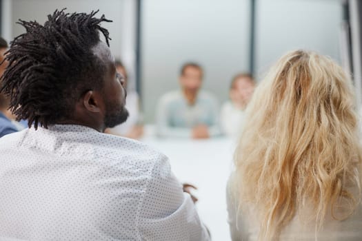 Multicultural businesspeople discussing work sitting at a round table