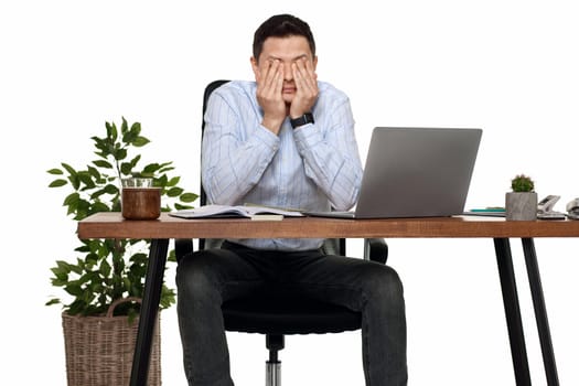 sad man have a headache, using laptop in office