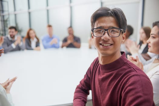 Young handsome businessman in glasses posing at camera