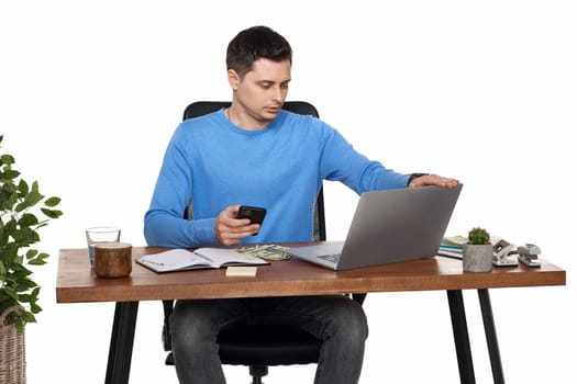 handsome businessman working with laptop and using smartphone on white background