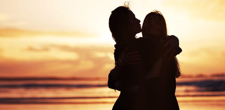 Spread love wherever you go. two young women spending the day at the beach at sunset