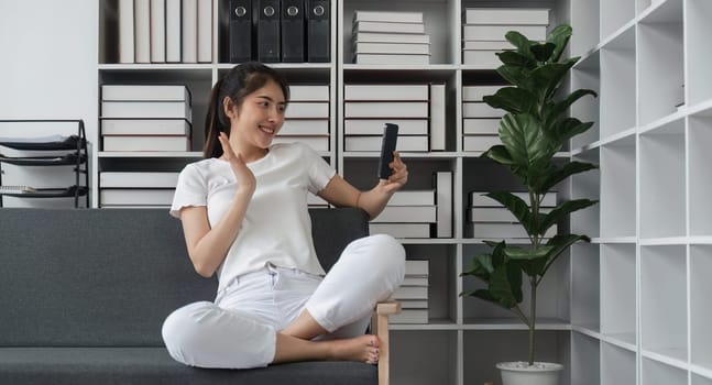 Asian woman making a video call to her friend, Online communication concept.