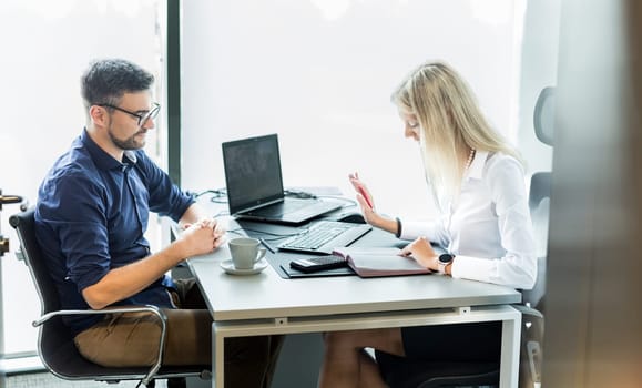 Business meeting. Client consulting. Confident business woman, real estate agent, financial advisor explaining details of project or financial product to client in office