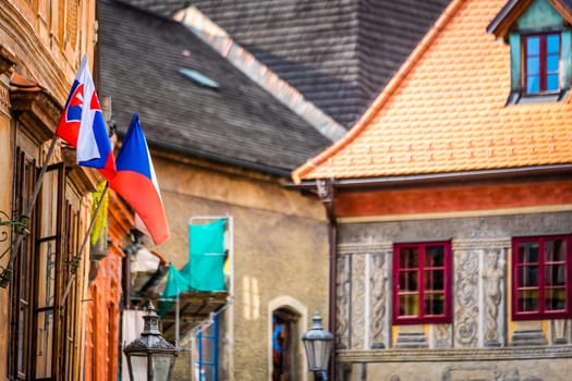 Side view of old building's architecture with nathional czech flags in Cesky Krumlov