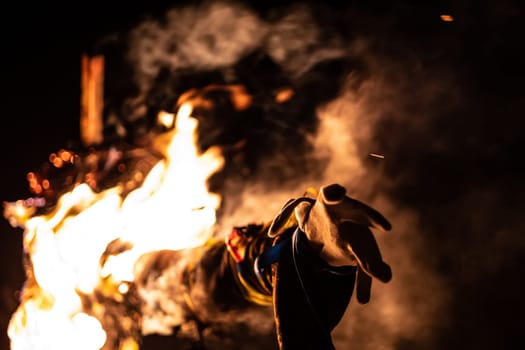 Burning ritual doll in flames on traditional holiday Maslenitsa