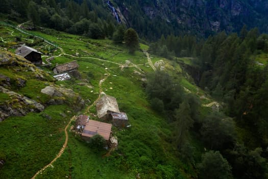 Small buildings standing high in beautiful Alps