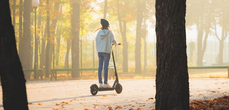 girl on scooter in autumn park
