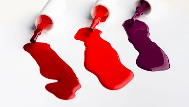 Shiny nail polish drops sample isolated on white