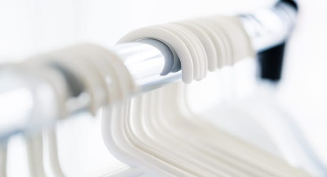 Row of empty white clothes hangers