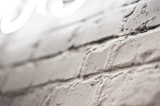 Close up view of textured brick wall with illumination