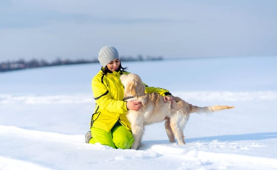 Beautiful girl with lovely dog outside in winter