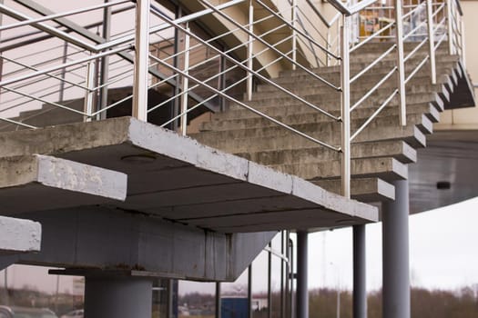 Staircase with metal railing on the sky background