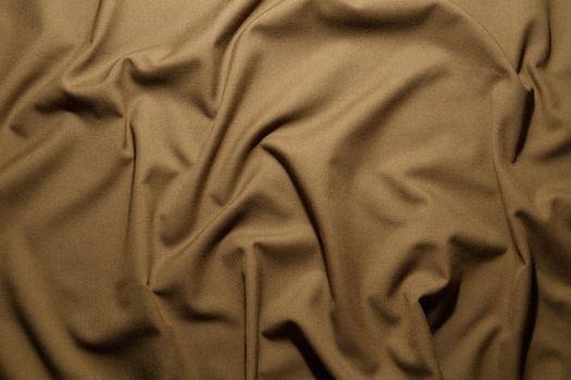 crumpled khaki tan crumpled tan khaki canvas fabric - full frame background and texture.