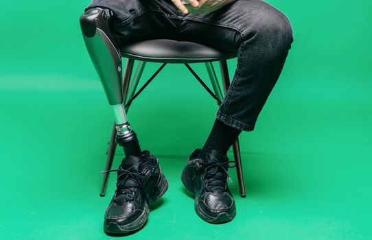 Disabled man with prosthetic leg, studio shoot