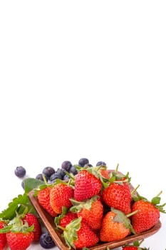 A bowl set of beautiful and delicious strawberry and blueberry isolated on white background, close up, copy space, clipping path, cut out.