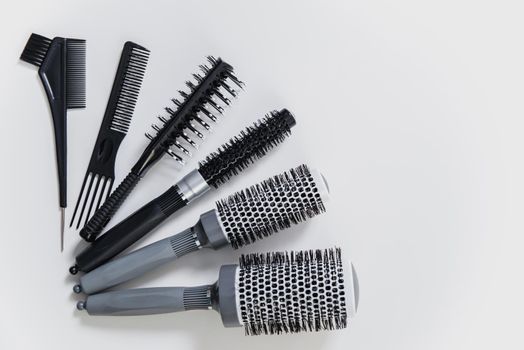 Set of professional hairbrushes on white background in a hair salon