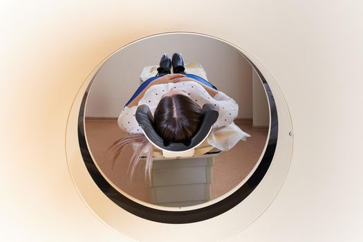 Female patient undergoing MRI - Magnetic resonance imaging in a Hospital. Medical Equipment and Health Care