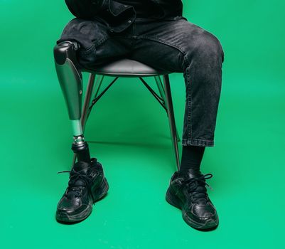Disabled man with prosthetic leg, studio shoot