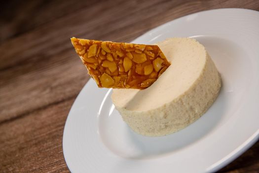 Bavarian recipe with pear and vanilla served with almond nougatine. High quality photo