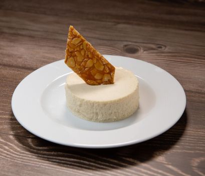 Bavarian recipe with pear and vanilla served with almond nougatine. High quality photo
