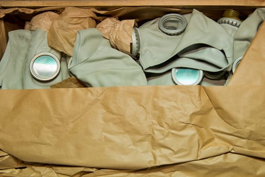 Soviet gas mask in a wooden box. Warehouse of Soviet protective equipment. Close-up.