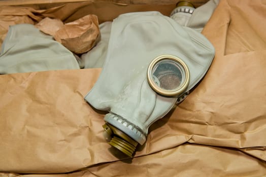 Soviet gas mask in a wooden box. Warehouse of Soviet protective equipment. Close-up.