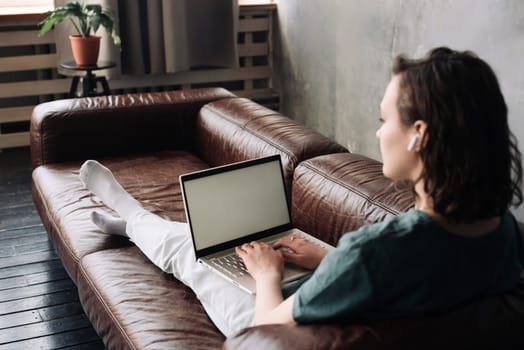 Modern Work and Connectivity: Young Woman Utilizing Laptop with Blank Screen at Home, Showcasing Versatility of Freelancing, Student Life, Online Education, Web Conferencing, Video Calls, Technology,
