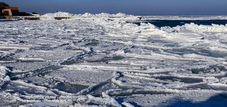 Ice Climatic collapse, heaps of ice blocks on the piers and the shore. The Black Sea near Odessa is frozen