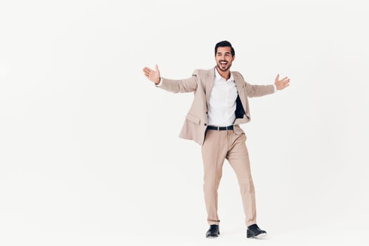 man background suit businessman beige smiling success portrait stylish business sexy smile running happy flying studio victory attractive work winner standing