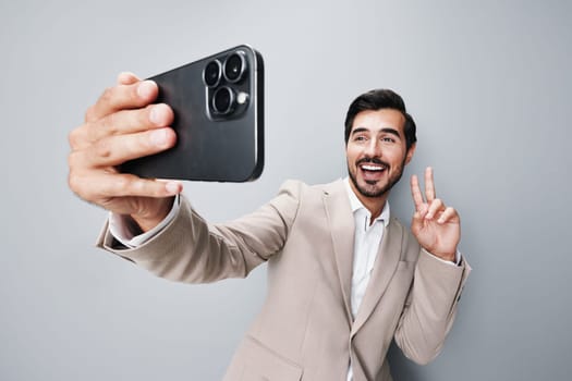 man business lifestyle hold success smile white portrait phone phone technology mobile background online smartphone cell happy beard beige young suit call