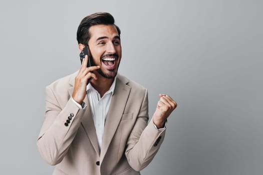 trading man internet guy connection portrait hold smartphone confident suit business call background cell young adult phone happy studio smile lifestyle