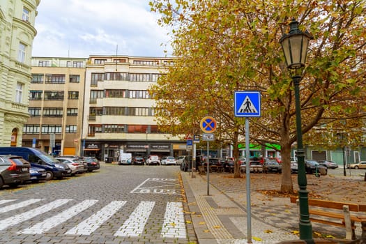 11 November 2022 Prague, Czech Republic. Street and parking for cars in the city, many signs and a pedestrian crossing.