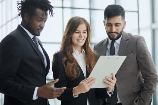 standing in modern office hallway, boss and subordinates ready for negotiations concept