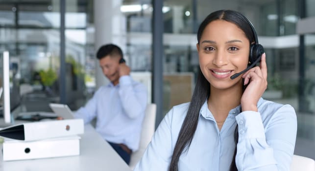 Woman in portrait, smile and call center with CRM, contact us and communication with headset at office. Happy female consultant in customer service, telemarketing or tech support with help desk job.