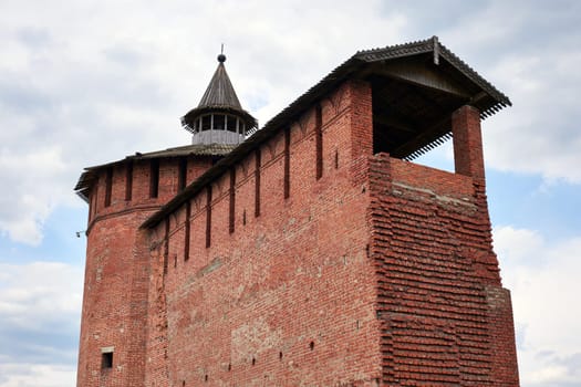 Part of an old fortress wall made of red brick against the sky