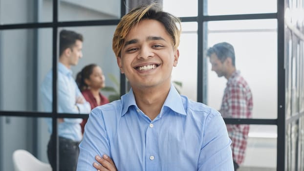 Portrait of a confident young boy wearing standing with his arms cross